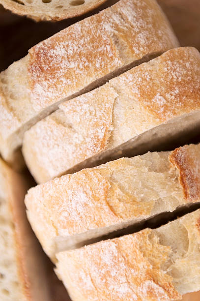 istock fresh bread - baguette cut into slices 180736444