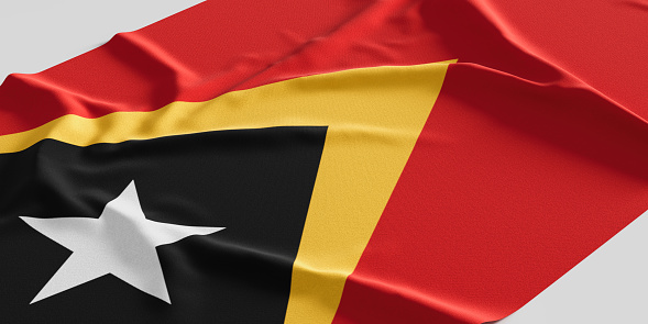 Flag of East Timor. Fabric textured East Timor flag isolated on white background. 3D illustration