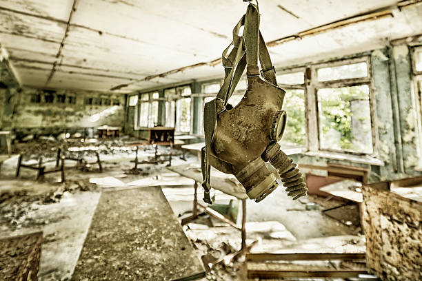 After Nuclear War Old and damaged gas mask hanged in an abandoned and ruined building. chornobyl photos stock pictures, royalty-free photos & images