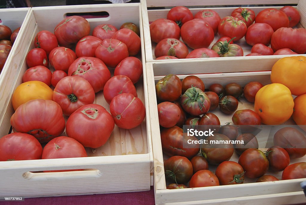 Heirloom Tomatoes at Farmers' Market "Various types of heirloom tomatoes, ready for selling at a farmers' market/" Farmer's Market Stock Photo