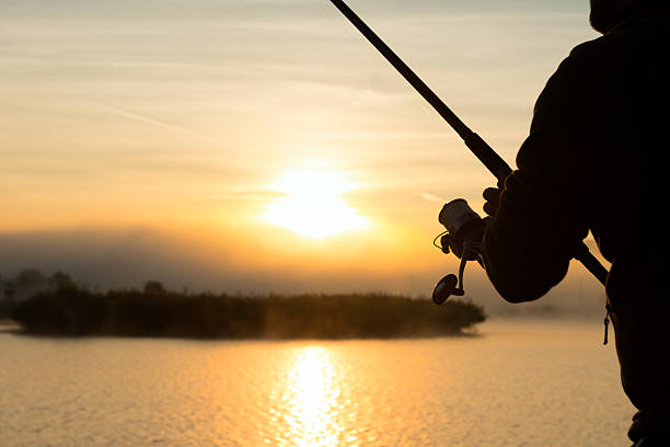 istock fishing rod in man hand 180738432