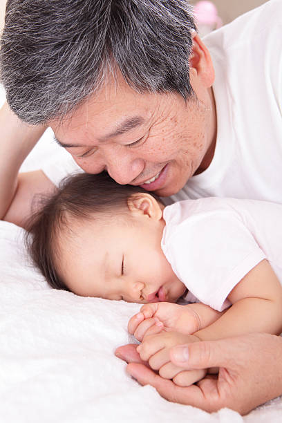 grandfather and his sleeping granddaughter "old grandfather and his sleeping granddaughter at home, asian familyFamily Love" sleeping grandpa stock pictures, royalty-free photos & images