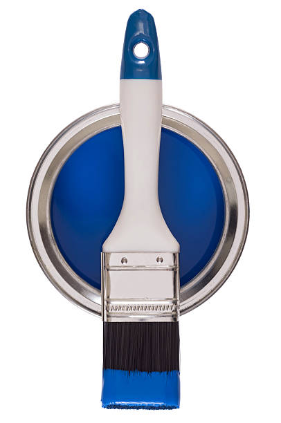 Paint brush on a tin of blue paint