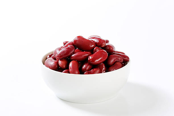 bowl of red beans bowl of cooked red beans on a white background kidney bean stock pictures, royalty-free photos & images