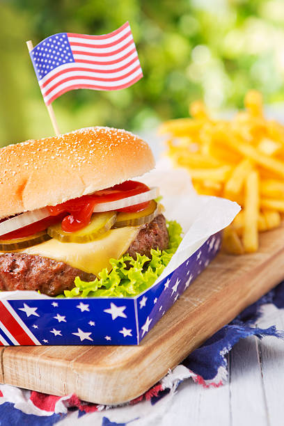 istock Burger with fries on an outdoor table in bright light 180739579