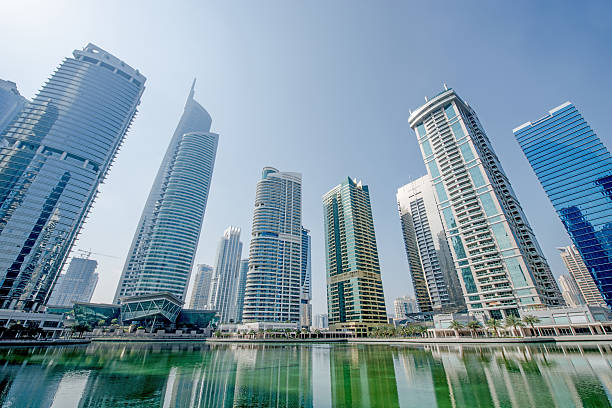 Lifestyle apartments and office development Waterfront cityscape of highrRise lifestyle apartments and offices with clear skies jumeirah stock pictures, royalty-free photos & images