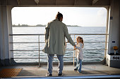 Girl traveling by ship with her father