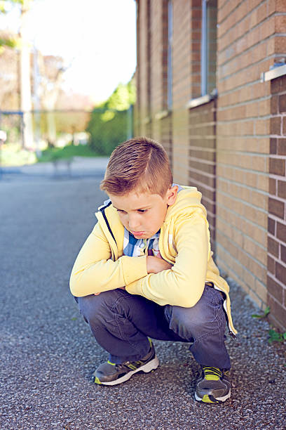 istock Sad boy at the school yard 180740831