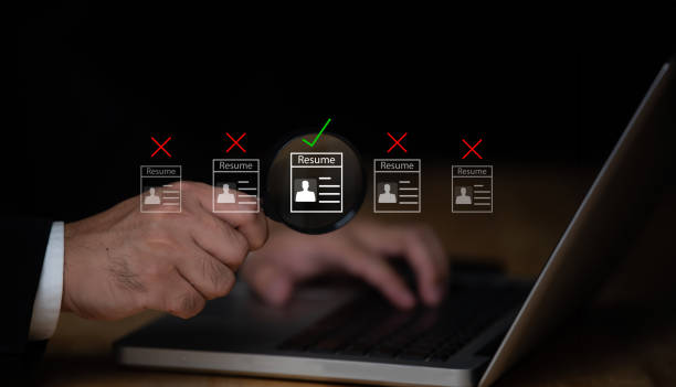 istock Businessman uses magnifying glass pointing at screen 1807413163