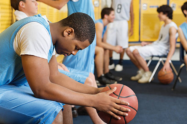 High school locker room with basketball team players High school locker room with basketball team players teenagers only teenager multi ethnic group student stock pictures, royalty-free photos & images