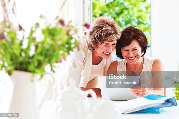 Mature Women Using Digital Tablet Stock Photo - Download Image Now - 60-64 Years, Active Seniors, Adult