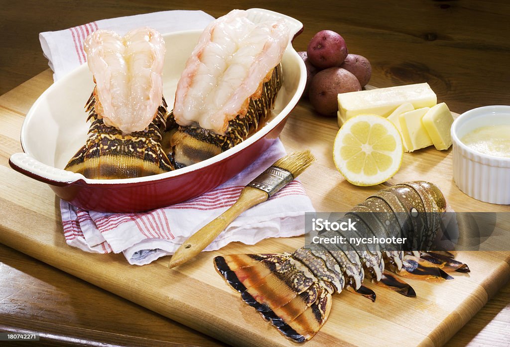 Lobster tail preparation Preparing lobster tail for dinner. Butter Stock Photo