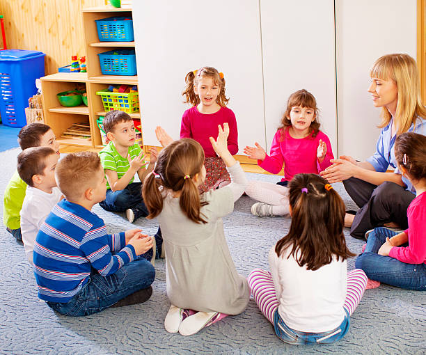 istock Teacher singing with children. 180742295