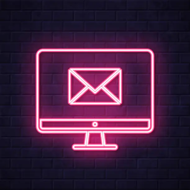 Vector illustration of Desktop computer with email message. Glowing neon icon on brick wall background