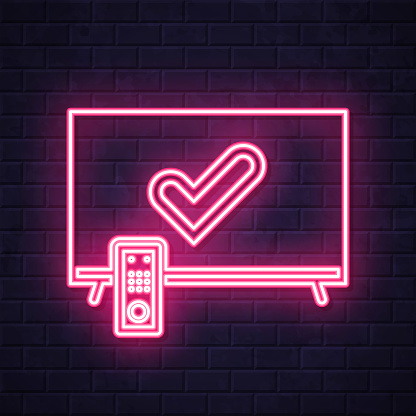 istock TV with check mark. Glowing neon icon on brick wall background 1807423480