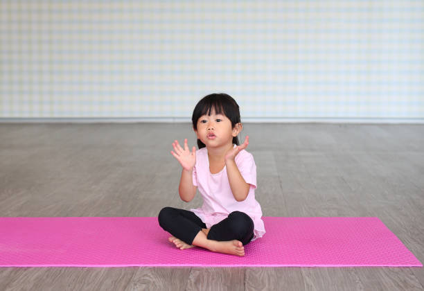 istock Little girl practicing yoga or exercise 1807426237
