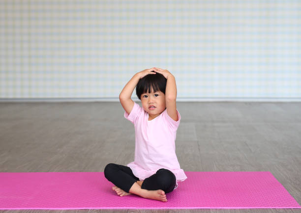 istock Little girl practicing yoga or exercise 1807426277