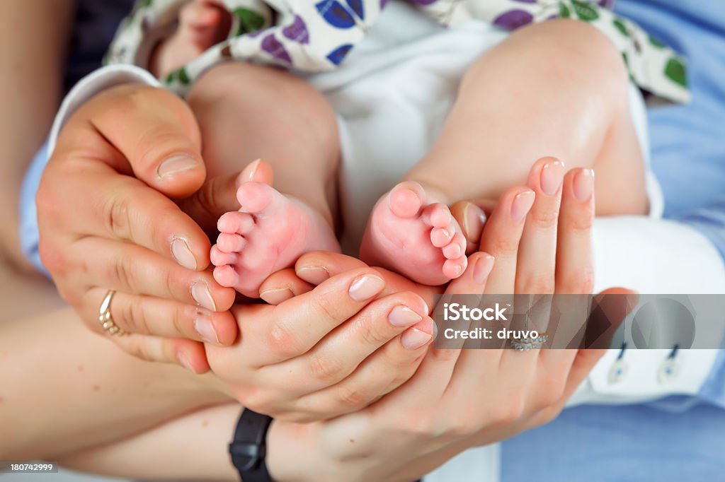 Родителей, держа ребенка ноги - Стоковые фото 0-11 месяцев роялти-фри