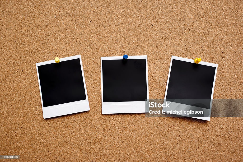 Blank Instant Photo Prints Three blank instant photo prints hanging on a cork message board Instant Print Transfer Stock Photo