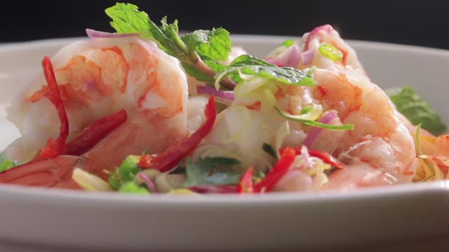 Lemongrass salad with fresh shrimp and thai herbs in close up shot