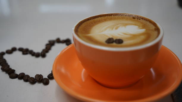 istock Orange Coffee Cup Creamed coffee and coffee Beans 1807439755