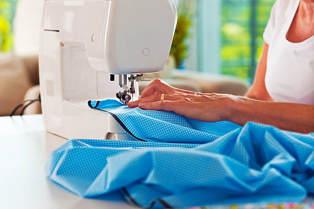 istock Woman sewing at home 180744210