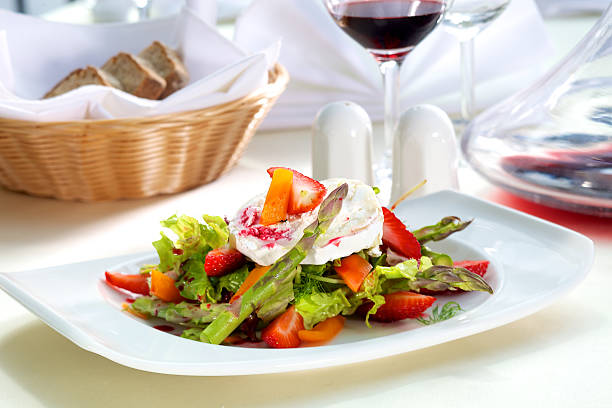 Fresh salad with goat cheese and asparagus with strawberries