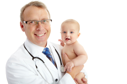 Portrait of a smiling doctor holding a happy baby isolated on white
