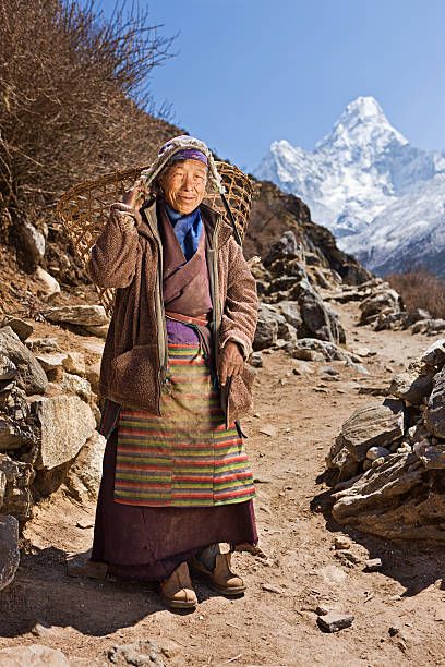 istock Old woman carrying basket 180744463