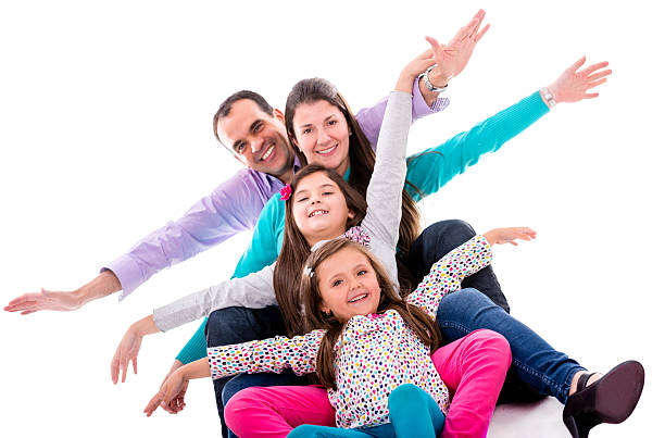 A young family with little two daughters to bed on white background