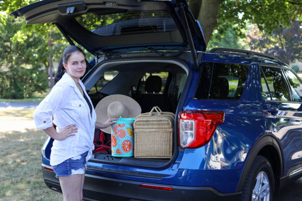 istock Smiling woman packing car for a trip 1807447256