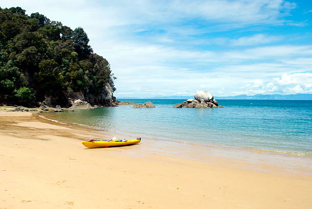 Kayak on Split Apple Rock Beach, New Zealand An abandoned Kayak on the iconic Split Apple Rock Beach in The Abel Tasman National Park, New Zealand. nelson city new zealand stock pictures, royalty-free photos & images