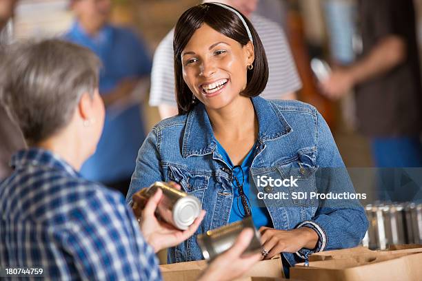 Volunteers Packing Donation Boxes At Food Bank Stock Photo - Download Image Now - Active Seniors, Adult, African Ethnicity