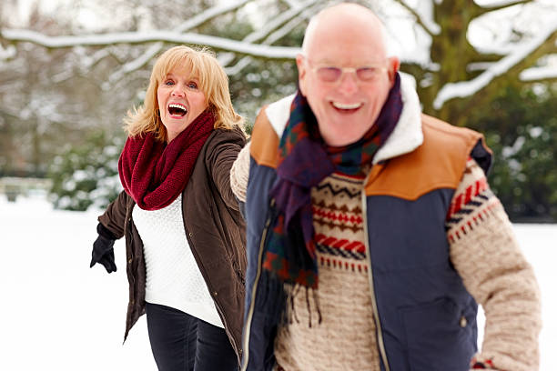 istock Active retired couple playing in the snow 180745022