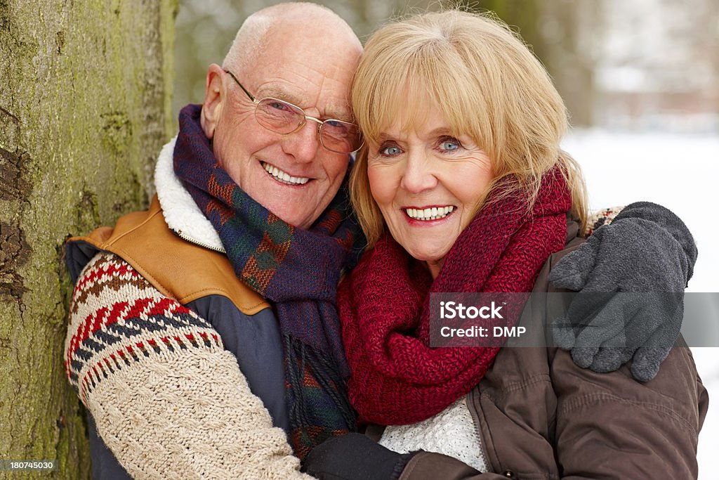 Happy mature couple in winter clothing smiling at camera Portrait of happy mature couple in winter clothing smiling at camera on a winter day 60-69 Years Stock Photo