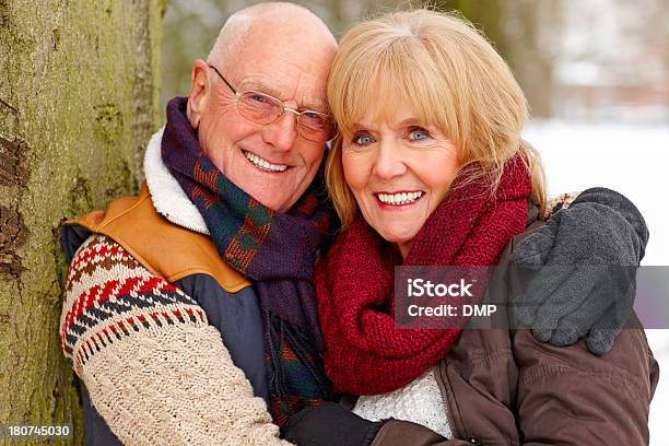 Happy Mature Couple In Winter Clothing Smiling At Camera Stock Photo - Download Image Now