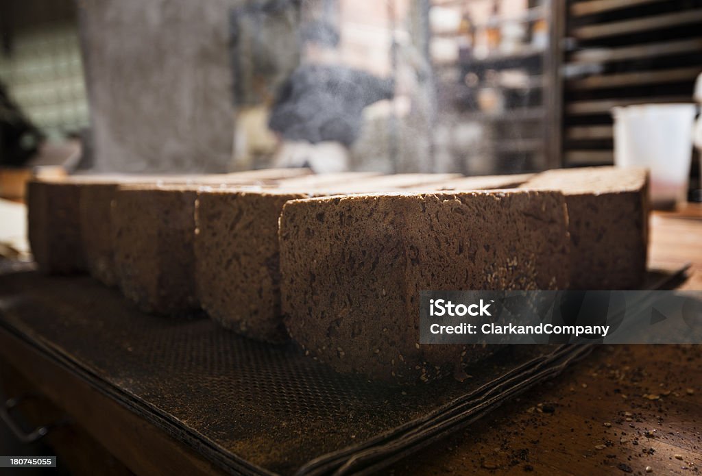 Fresh Rye Bread Freshly baked rye bread cooling rapidly and producing steam. Photographed in a bakery in a traditional bakery in Denmark. Loaf of Bread Stock Photo