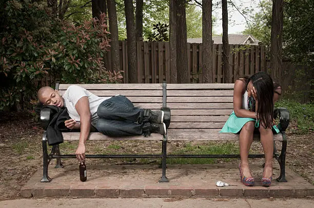 Photo of Hungover Couple on Park Bench