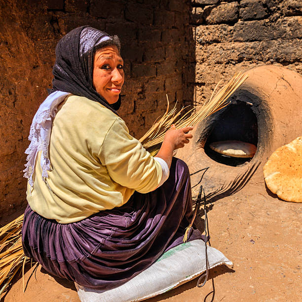 istock Moroccan woman making bread - khubz 180745428