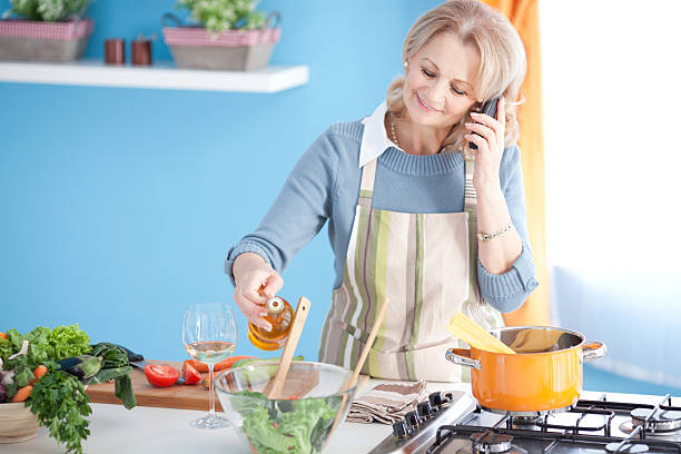 istock Senior woman cooking. 180745429