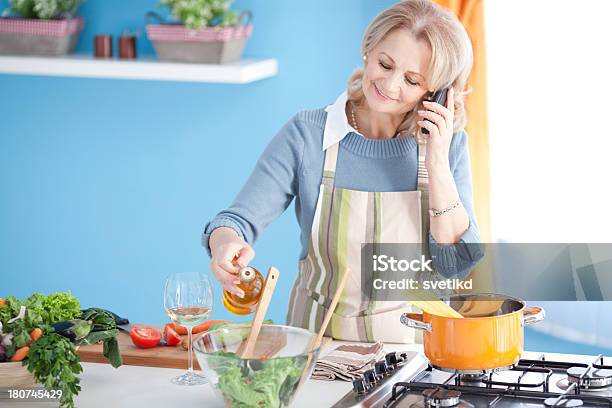 Senior Woman Cooking Stock Photo - Download Image Now - 50-59 Years, Active Seniors, Adult