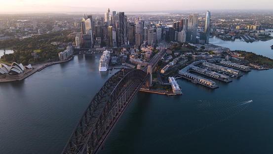 Aerial view of Sydney City from above Sydney Harbour and Harbour Bridge, NSW Australia on a sunny early morning in November 2023