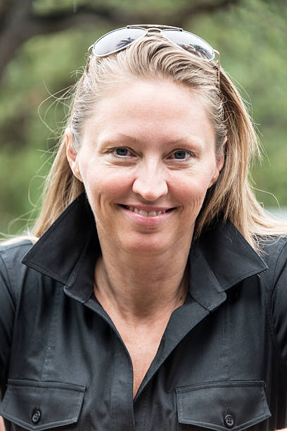 istock smiling middle aged woman in black jacket 180746135