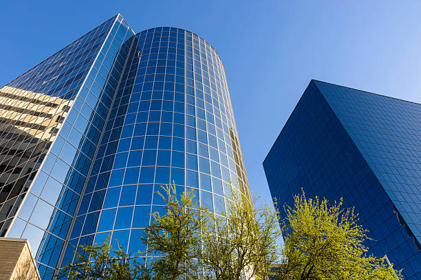Denver, Colorado - February 12 2023: A view of the mirrored reflection of a downtown highrise in the moments before the sun rises in the eastern sky and before the city wakes up.