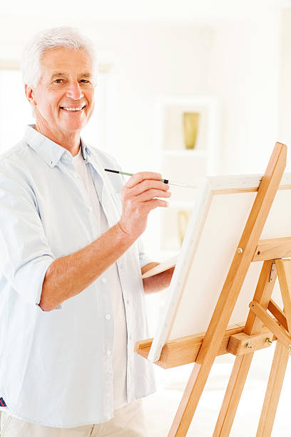 istock Senior Man Painting On Canvas 180746237