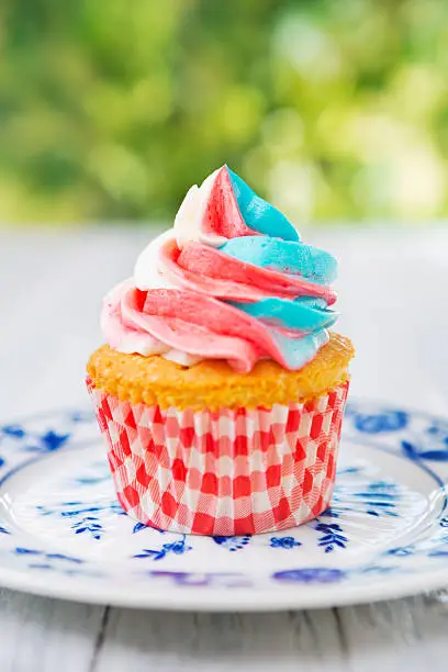 Red-white-and-blue cupcake on an outdoor table.