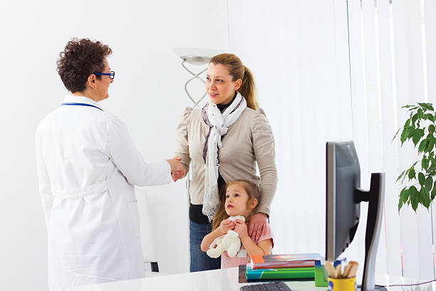 istock Mother and her daughter during visit at the doctor's office. 180746903