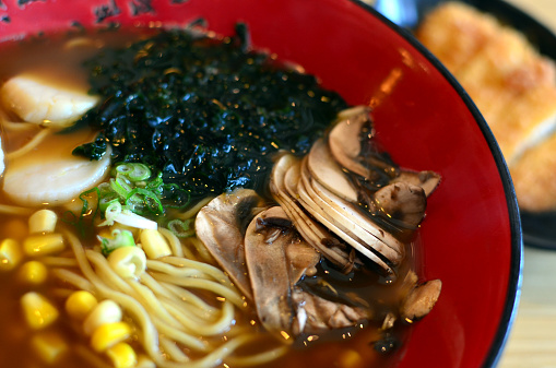 Japanese noodles soup with scallops, seaweed, corns, mushrooms and green onions.
