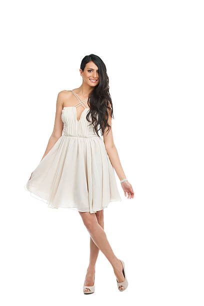 Do you like my dress? Pretty young woman in a cocktail dress against a white background curtseying stock pictures, royalty-free photos & images