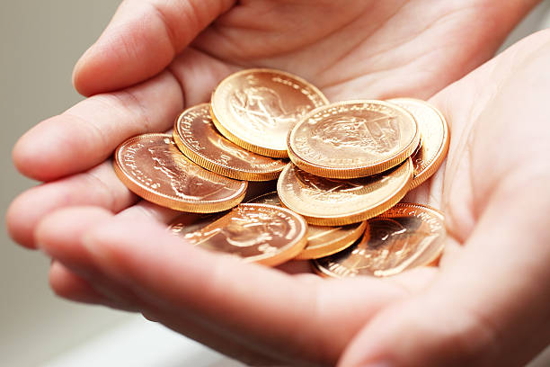 istock Handful of Gold Coins 180747590